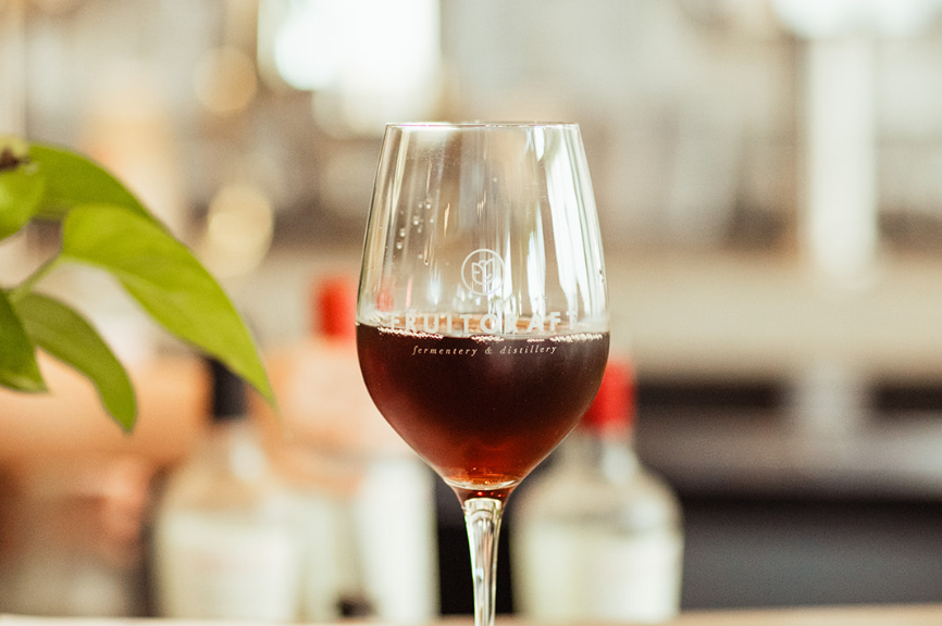 A glass of red fruit wine served at FruitCraft, highlighting their natural, fruit-based wine offerings.