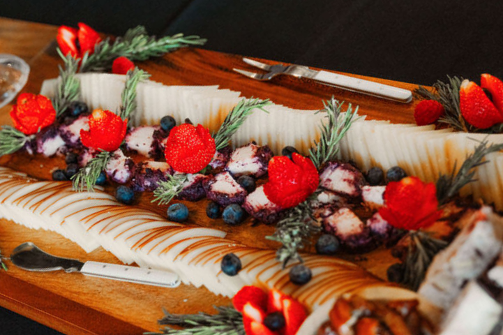 Artisanal charcuterie board featuring cheeses, fruits, and cured meats at a FruitCraft event.