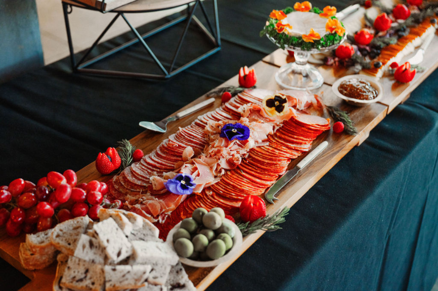 A rustic charcuterie board featuring fresh fruits, artisan cheeses, and accompaniments at FruitCraft.
